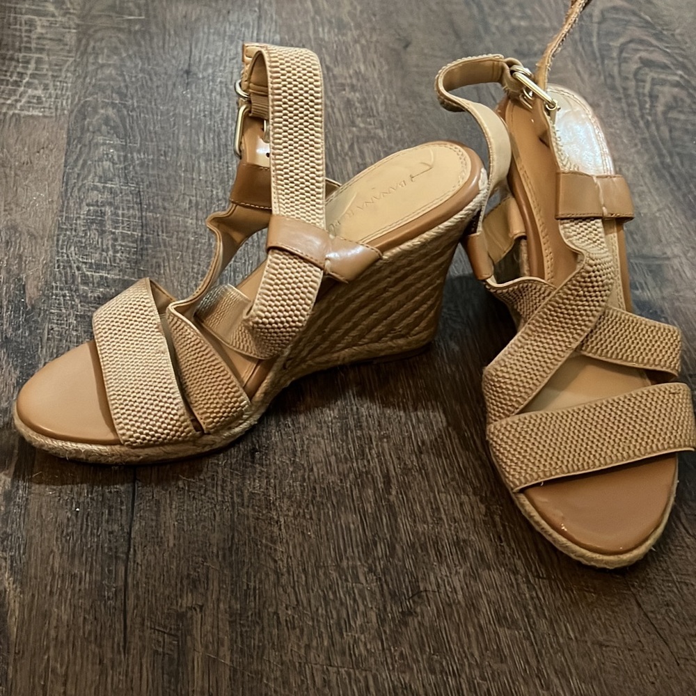 Tan strappy sandal with wedge heel.